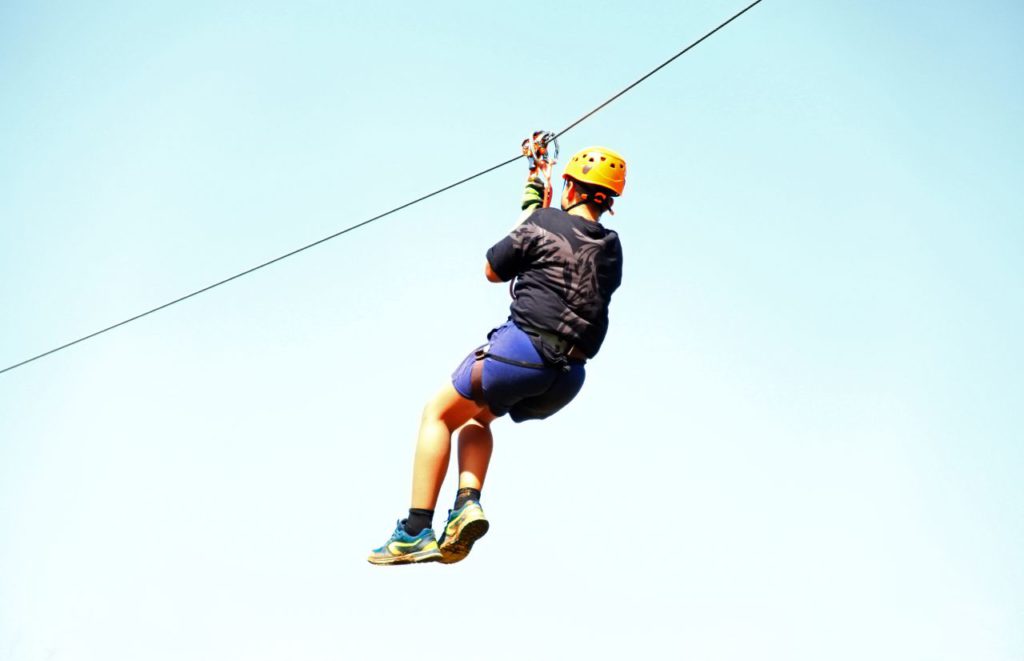 Teenager on a zipline. Keep reading to get the full guide on Orlando birthday celebrations.