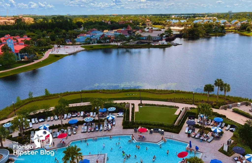An aerial view of Disney's Riviera Resort in Orlando Florida shows the pool area, a large lake, and other hotels across the water. Keep reading for more options for where to stay in Orlando Florida. 