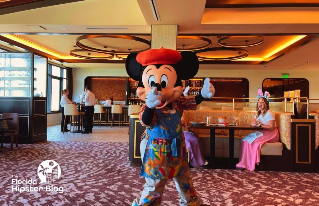 Mickey Mouse entertains guests in red beret and paint-splattered apron at Disney's Riviera Resort in Orlando, Florida. Keep reading for more options for where to stay in Orlando, Florida.