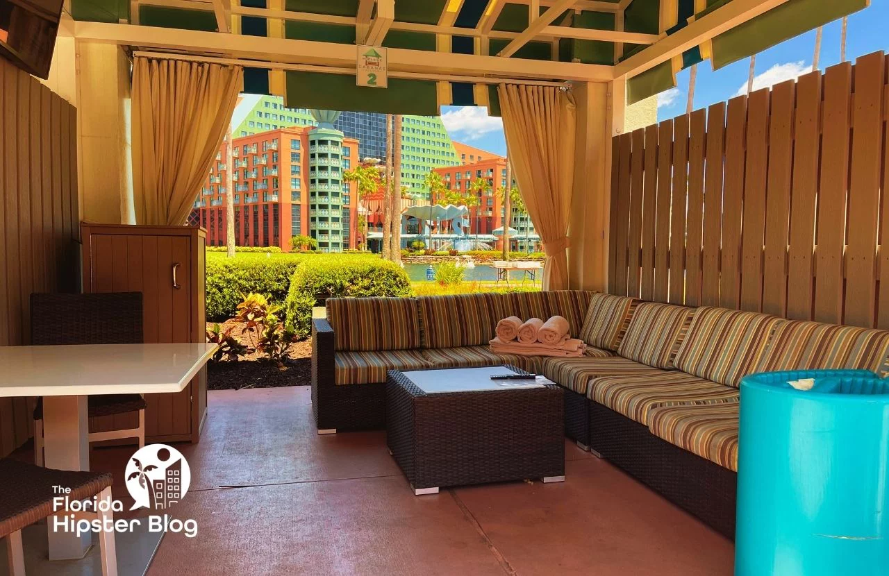 A cabana at the Walt Disney Swan and Dolphin Resort in Orlando Florida features a couch and table. Keep reading for more options for where to stay in Orlando Florida. 