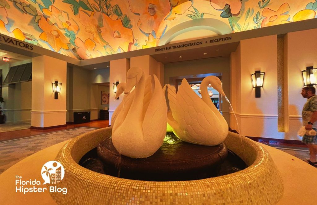 Disney Swan and Dolphin Resort Hotel in Orlando, Florida Lobby with white swans. Keep reading to find out things to do in Orlando for couples.