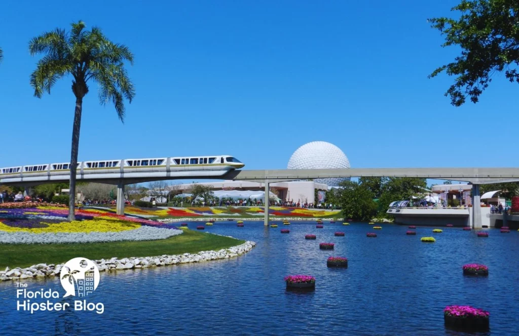 Monorail passes over water and in front of Epcot at Walt Disney World in Orlando, Florida. Keep reading for more romantic getaways in Orlando.