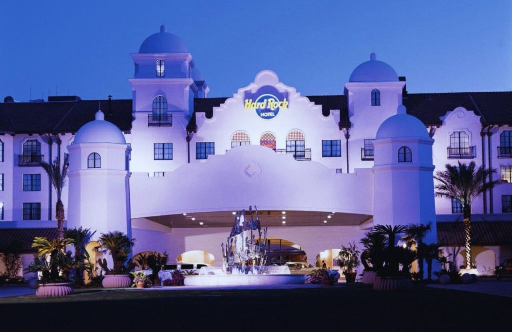 Exterior of the Hard Rock Hotel with massive white building and many windows at the Universal Orlando Resort in Orlando, Florida. Keep reading for more romantic getaways in Orlando.