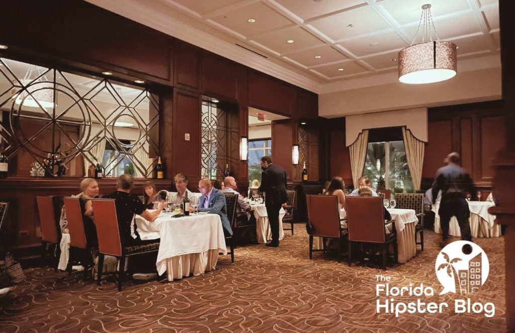 People eat at tables at the Waldorf Astoria Orlando in Orlando, Florida. Keep reading for more options for where to stay in Orlando, Florida.