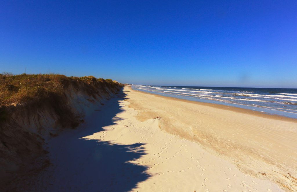 The view of an empty beach at Crescent Beach in Florida. Keep reading for more places to take a perfect day trip from Orlando, Florida. 