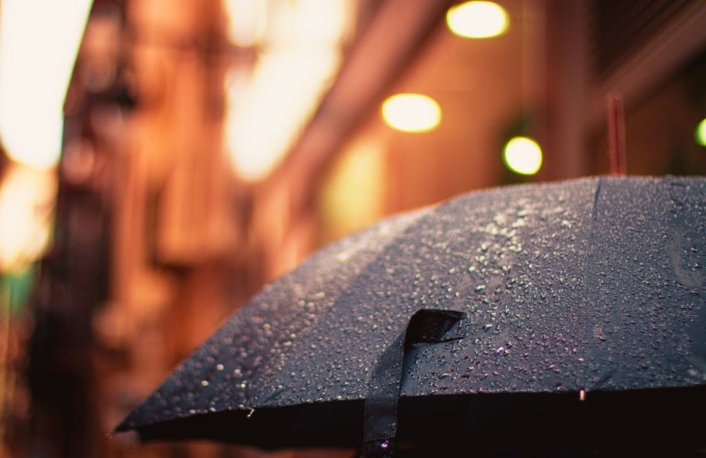 Foldable Black Umbrella in rain. Can I bring umbrella on plane? Keep reading to learn how.