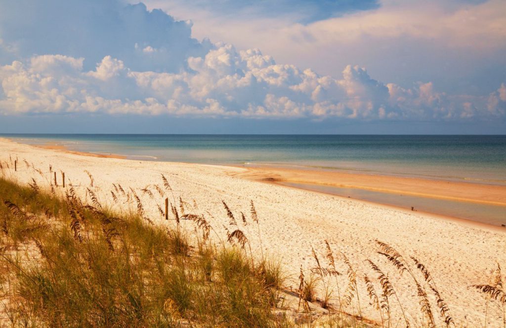 Gulf of Mexico with sandy shores, sand dunes and beautifully calm water of different blues. Keep reading to learn more of what to do in Cape San Blas. 