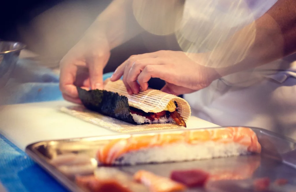 A chef folds a sushi roll at Haiku Tampa in Tampa, Florida. Keep reading for more places to get the best sushi in Tampa, Florida.