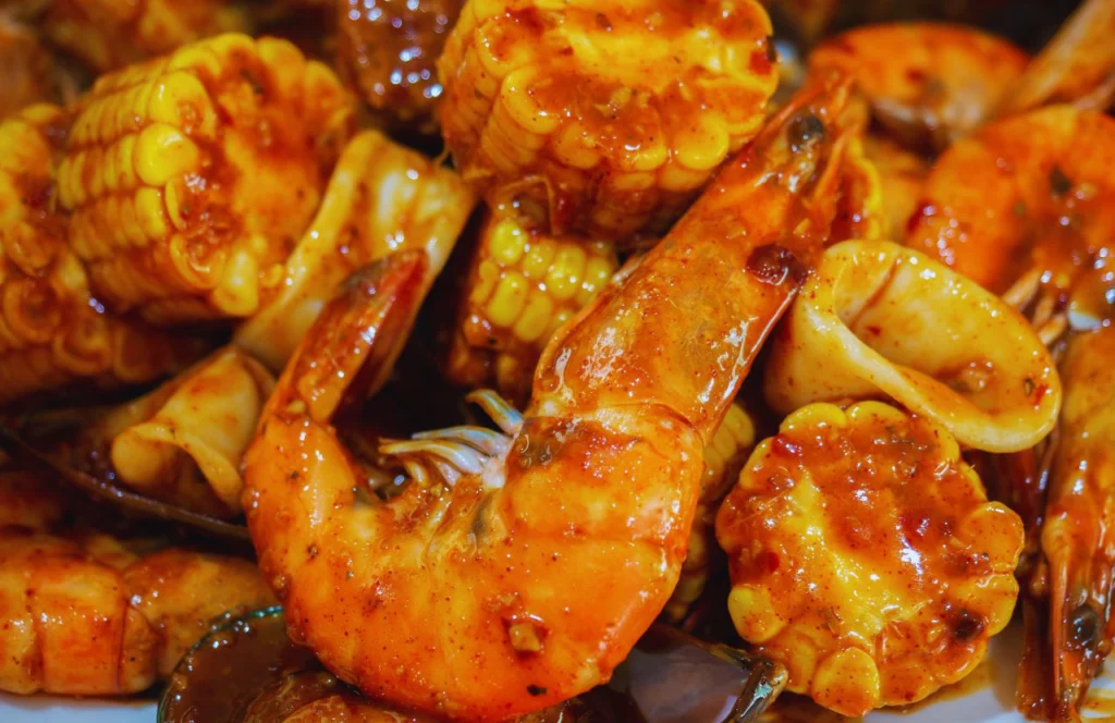Crawfish and corn tossed in a sauce at Hot N Juicy Crawfish in Orlando, Florida. Keep reading for more places to get the best crab legs in Orlando, Florida.