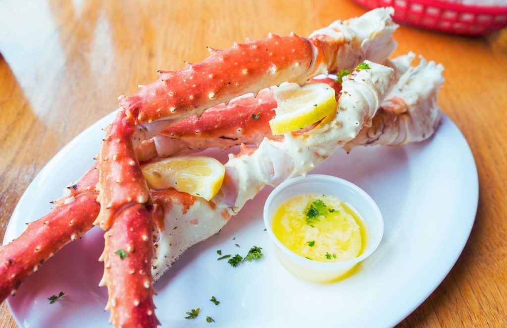 Crab legs with butter at J Crab House in Orlando, Florida. Keep reading for more places to get the best crab legs in Orlando, Florida. 