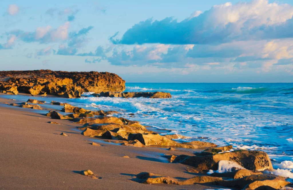 The rocky beach at Jupiter Beach in Florida. Keep reading for more places to take a perfect day trip from Orlando, Florida. 