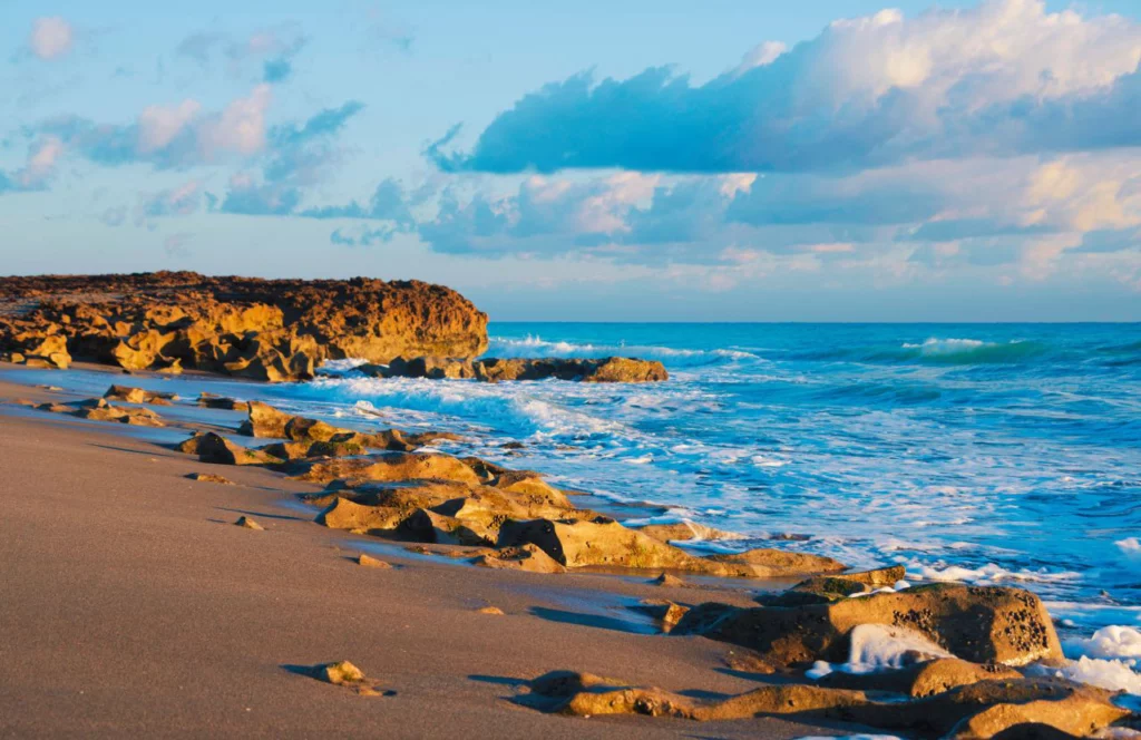 The rocky beach at Jupiter Beach in Florida. Keep reading for more places to take a perfect day trip from Orlando, Florida.