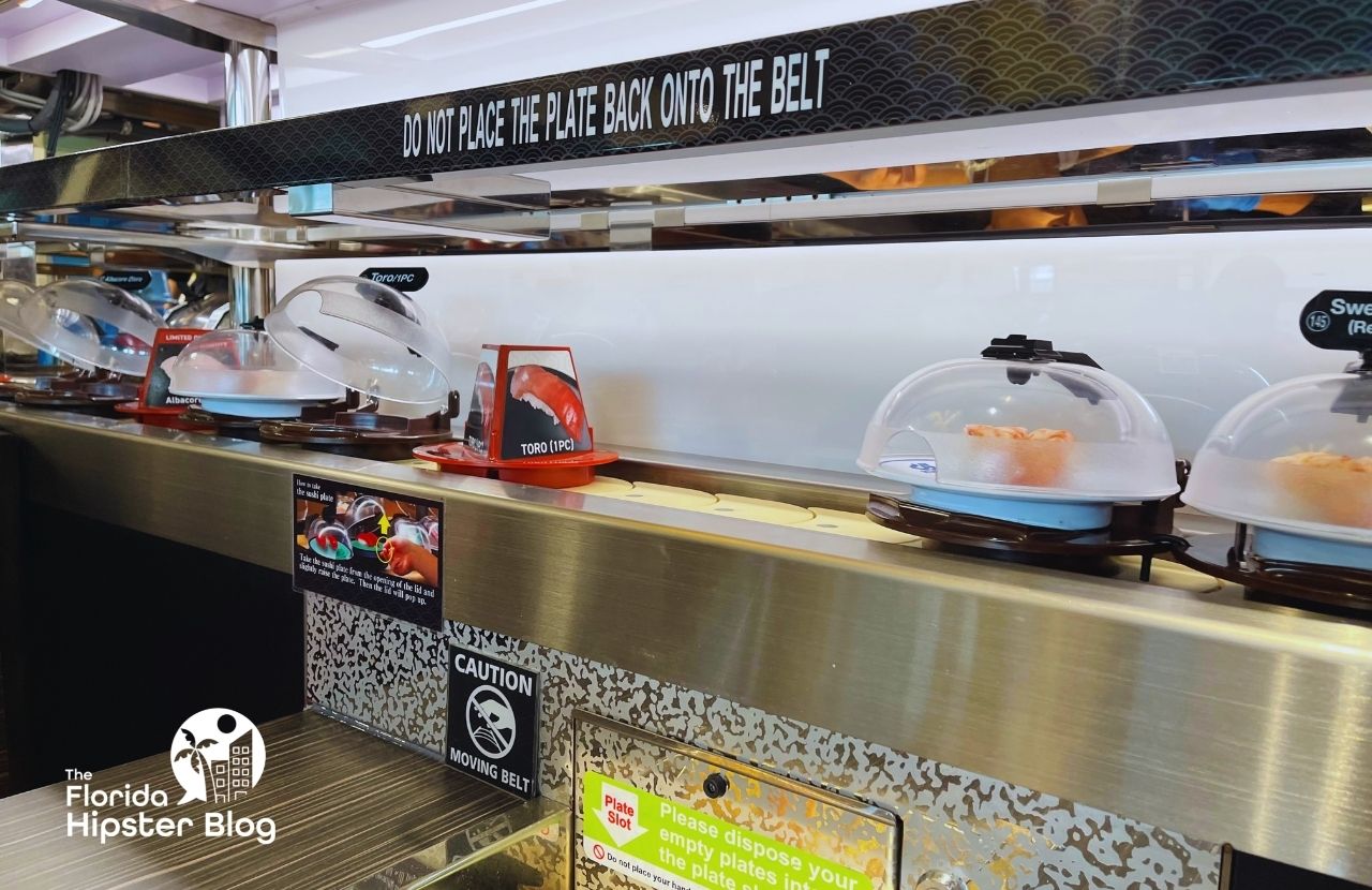 Kura Revolving Sushi Bar Restaurant in Orlando, Florida. Keep reading to get the best lunch in Orlando!