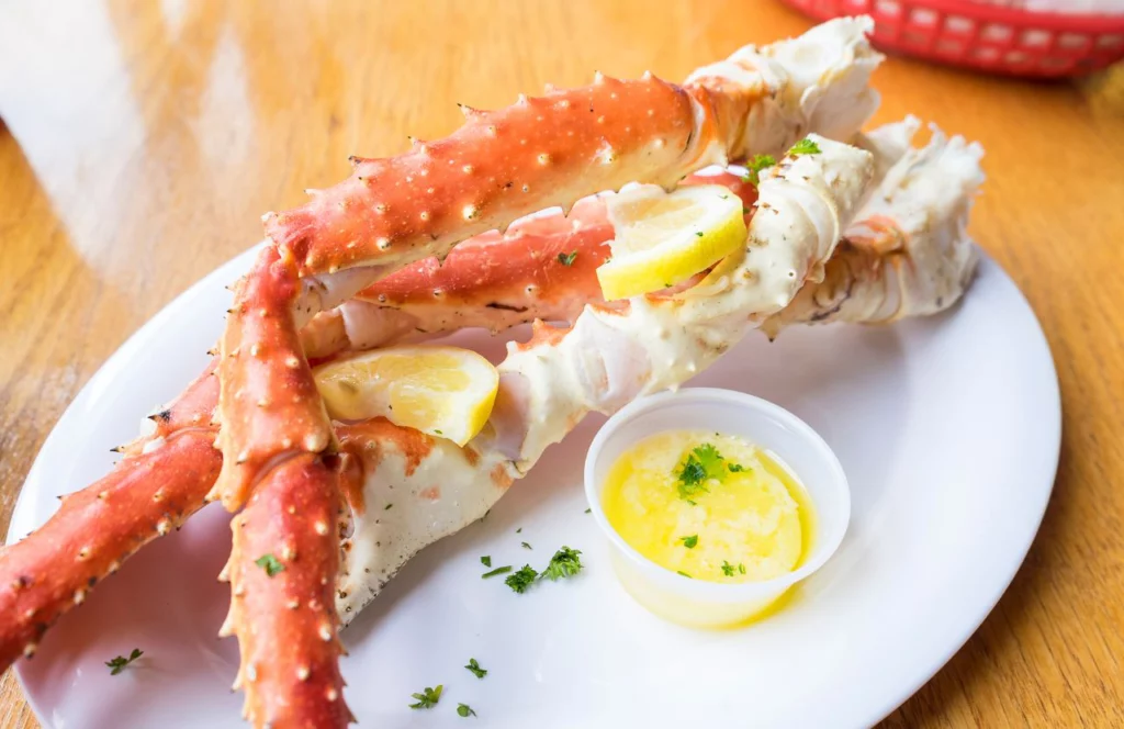 Crab legs served with lemon and melted butter at Mr. & Mrs. Crab Juicy Seafood in Orlando, Florida. Keep reading for more places to get the best crab legs in Orlando, Florida. 