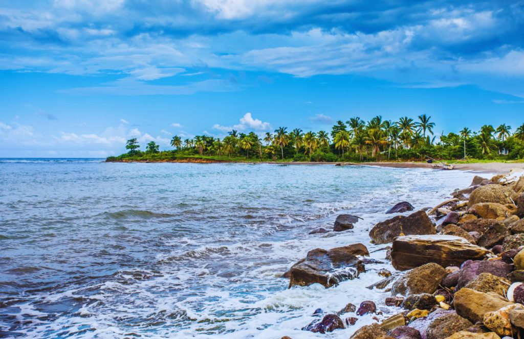 Waves crash on the rocks in Palm Bay, Florida. Keep reading for more places to take a perfect day trip from Orlando, Florida. 