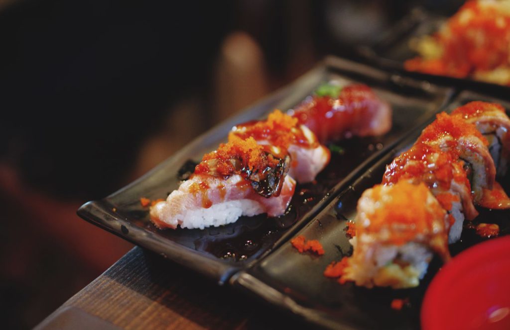 Various dishes of sushi and nigri on dark plates. Keep reading to learn more about the best sushi in Tampa. 