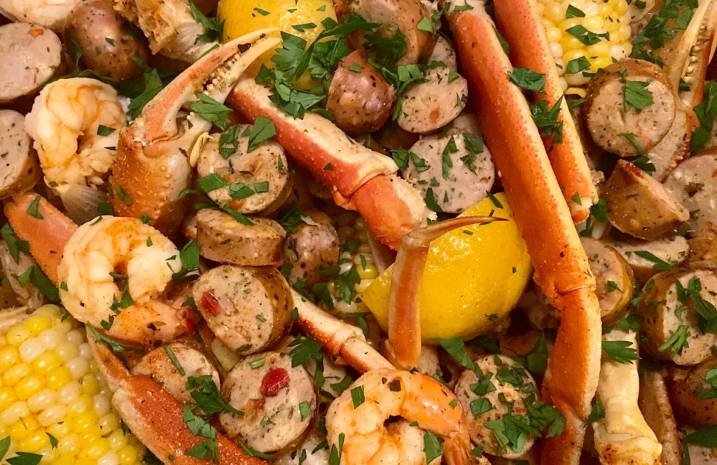Crab legs tossed in spices and served with lemon, sausage, and corn at The Juicy Crab in Orlando, Florida. Keep reading for more places to get the best crab legs in Orlando, Florida. 