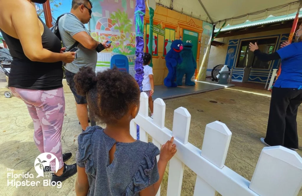 Things to do in Tampa Bay, Florida Busch Gardens Sesame Street Safari of Fun with little girl looking at Cookie Monster and Grover