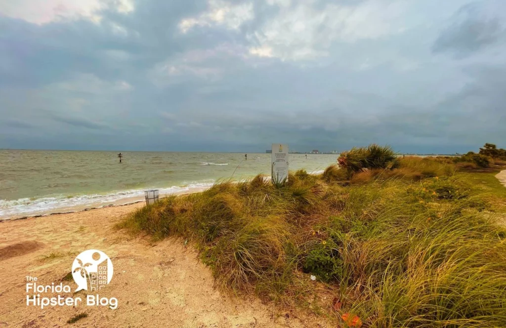 Things to do in Tampa Bay, Florida Cypress Point Beach Park on Cloudy Rainy and windy day. Keep reading to get the best rain ponchos for travel to Florida.