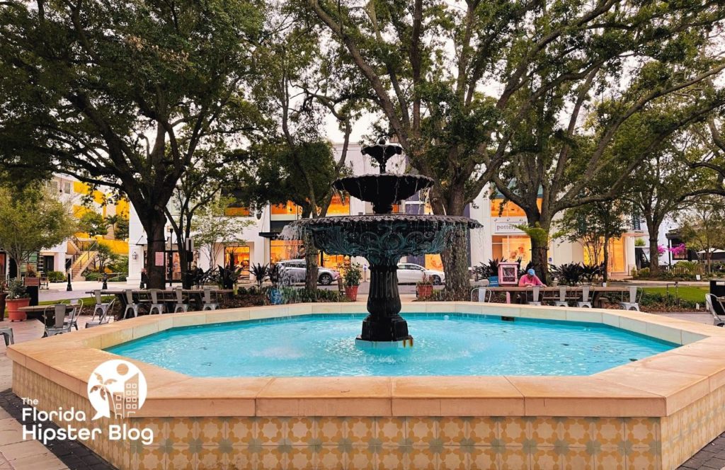 Things to do in Tampa Bay, Florida Hyde Park showing the blue water fountain surrounded by trees in the park. Keep reading to find out all you need to know for your next day trip from Gainesville.