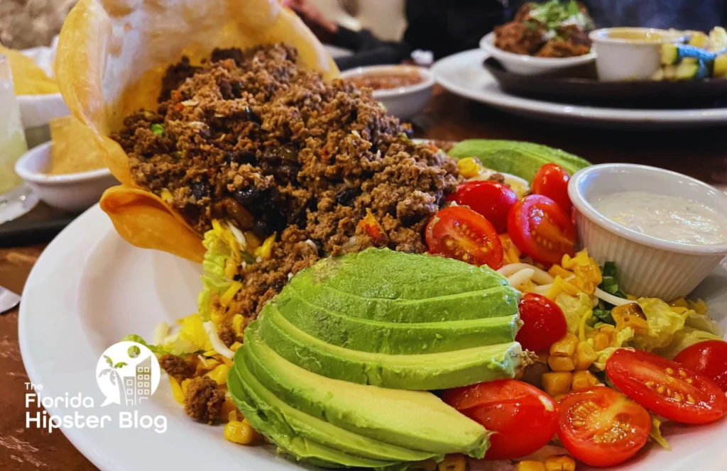 Large Taco Salad with ground beef tomatoes and avocado at Uncle Julio's Tex Mex Restaurant in ICON Park in Orlando, Florida. Keep reading to find out more about things to do in Orlando tonight.