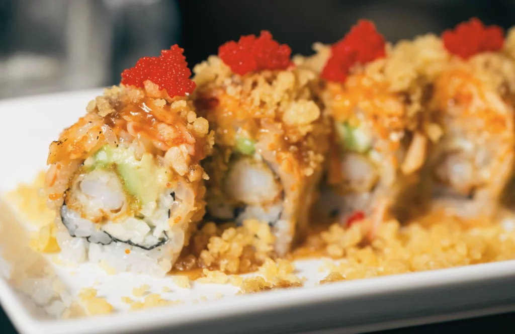 A sushi roll sits on a plate at Yoko's in Tampa, Florida. Keep reading for more places to get the best sushi in Tampa, Florida. 
