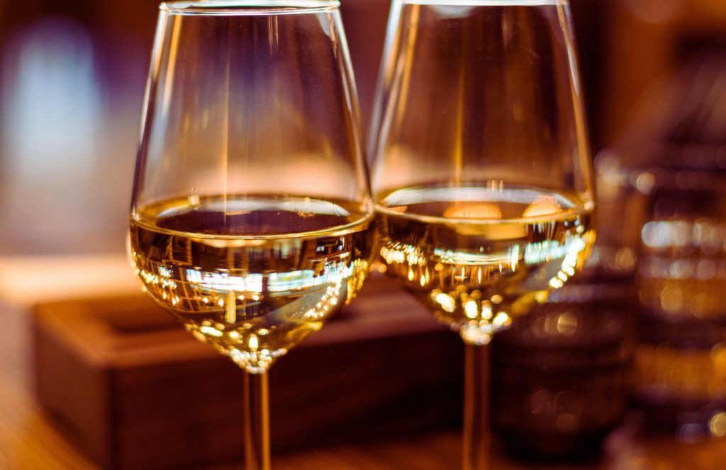 Two glasses of white wine on the table. Keep reading to learn more about things to do in Orlando at night.