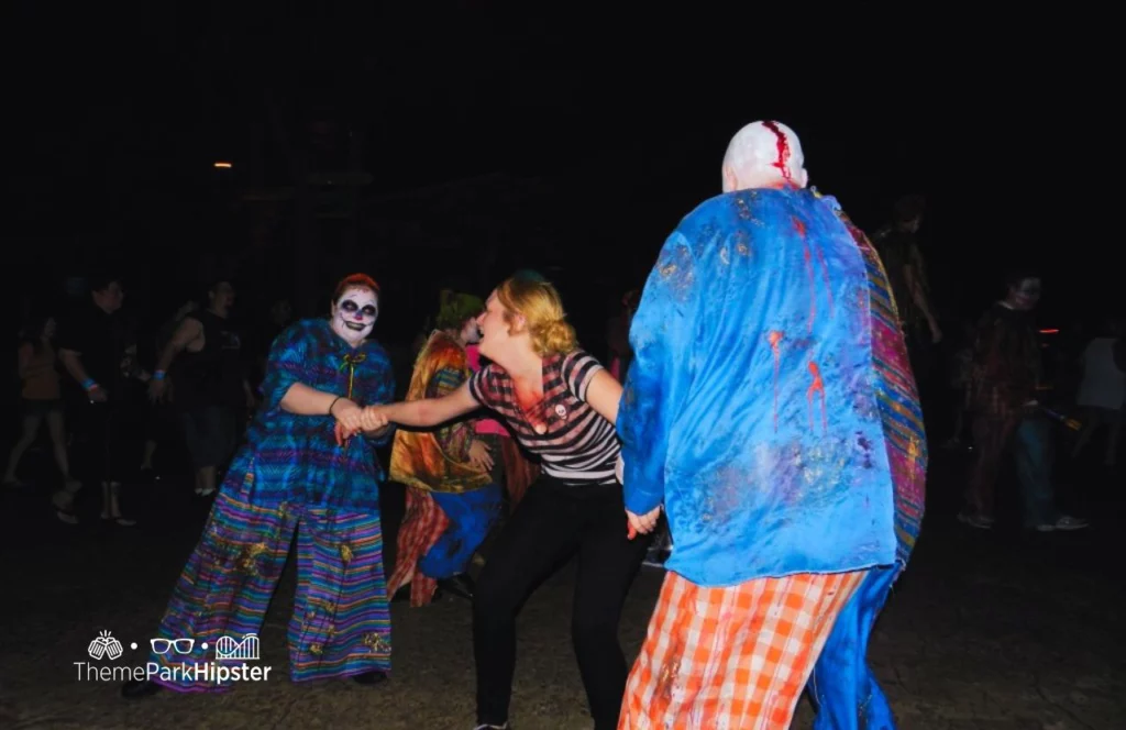Busch Gardens Tampa Howl O Scream with Girl being grabbed by clowns. Keep reading to get the best things to do in Florida for Halloween and Fall!