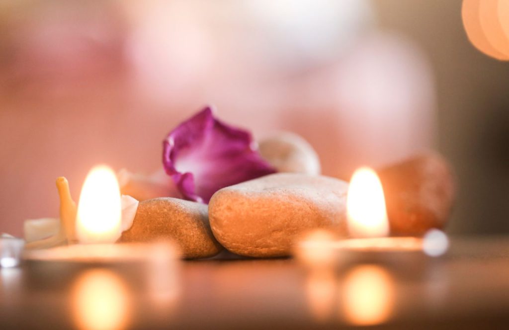 Candles lit on the table at Enchanteria Day Spa. Keep reading to find out all you need to know about the best spas in Tampa. 