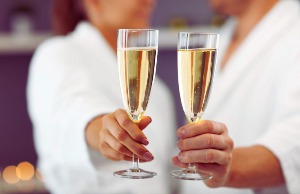 Couple toasting with champagne at JW Marriott Spa Downtown One of the Best Day Spas in Tampa, Florida. Keep reading to find out more about the best hotels in Tampa. 