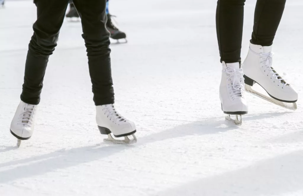 Two people ice skating during winter festivities. Keep reading to find out more Christmas events in Florida for 2023.