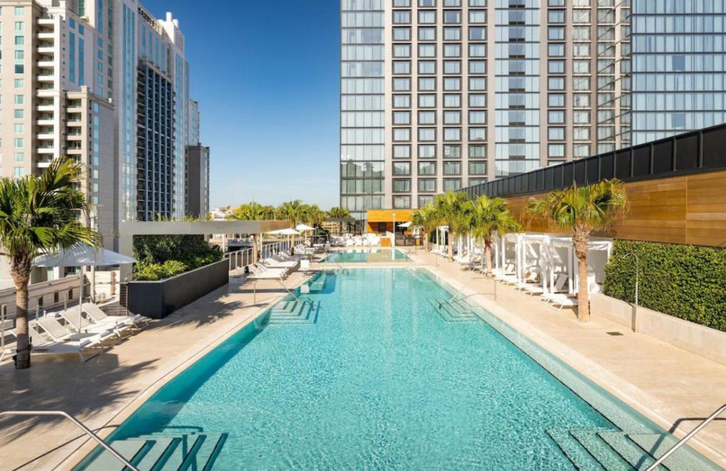 JW Marriott Tampa Water Street Spa Downtown with the crystal-clear pool sparkling in the sunshine with lounge chairs and cabanas on deck. Keep reading to get the best places to watch sunset in Tampa.
