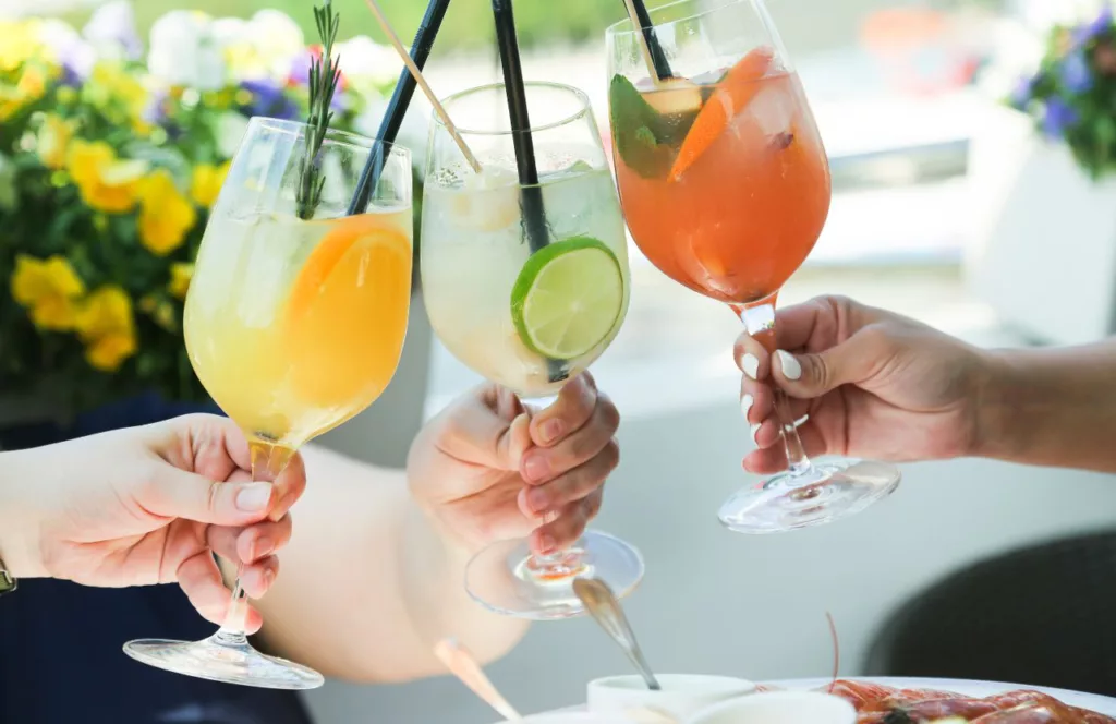 People toasting with cocktails at Thee Tree House A place to get the best brunch in Tampa, Florida. Keep reading to find out all you need to know about the best Tampa brunch spots.  