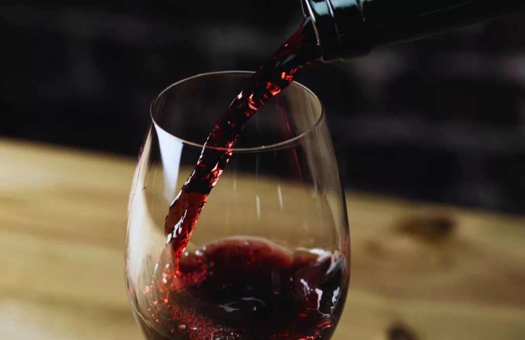 Red wine poured into a wine glass. Keep reading to learn more about Orlando birthday celebrations.