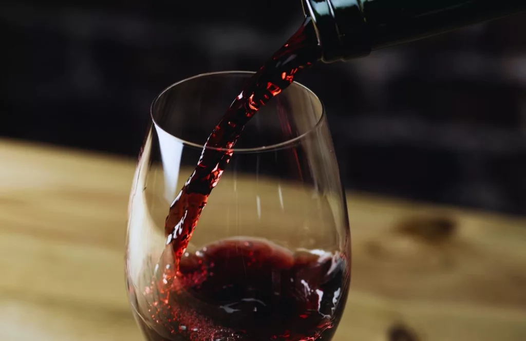 Pouring Red Wine into a wine glass. Keep reading to find out all you need to know about Orlando steakhouses.