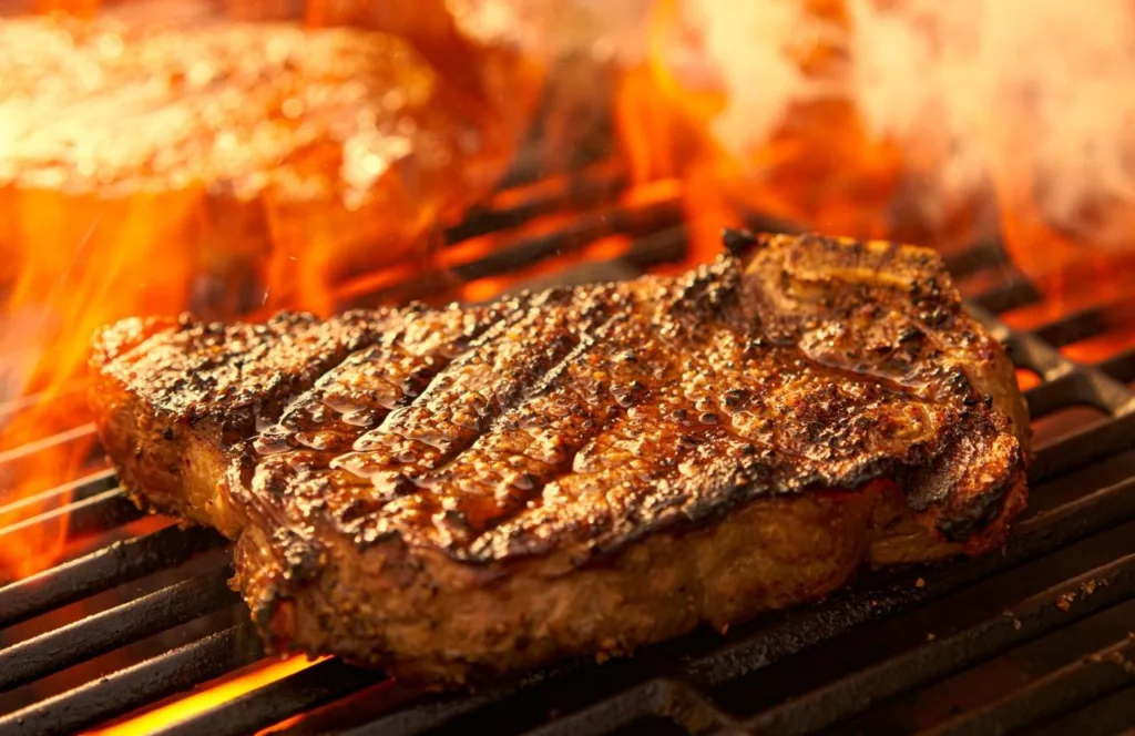 Steak cooking on the grill. Keep reading to find out more about the best restaurants in Gainesville. 