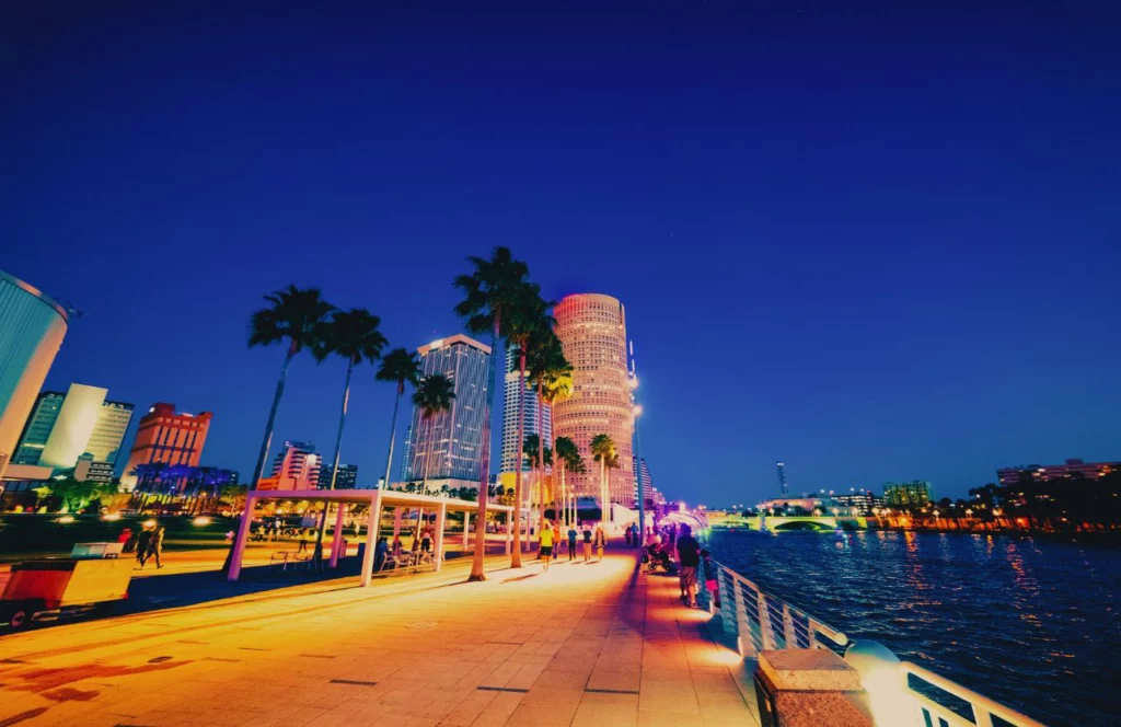 Tampa Riverwalk at night glowing at night. Keep reading to discover what to do in Tampa that is free. 