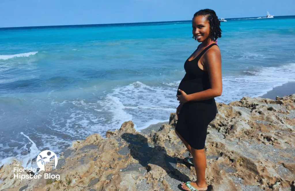 NikkyJ at Jupiter Beach Florida Splashing Rocks. Keep reading to get the best beaches in florida for bachelorette party.