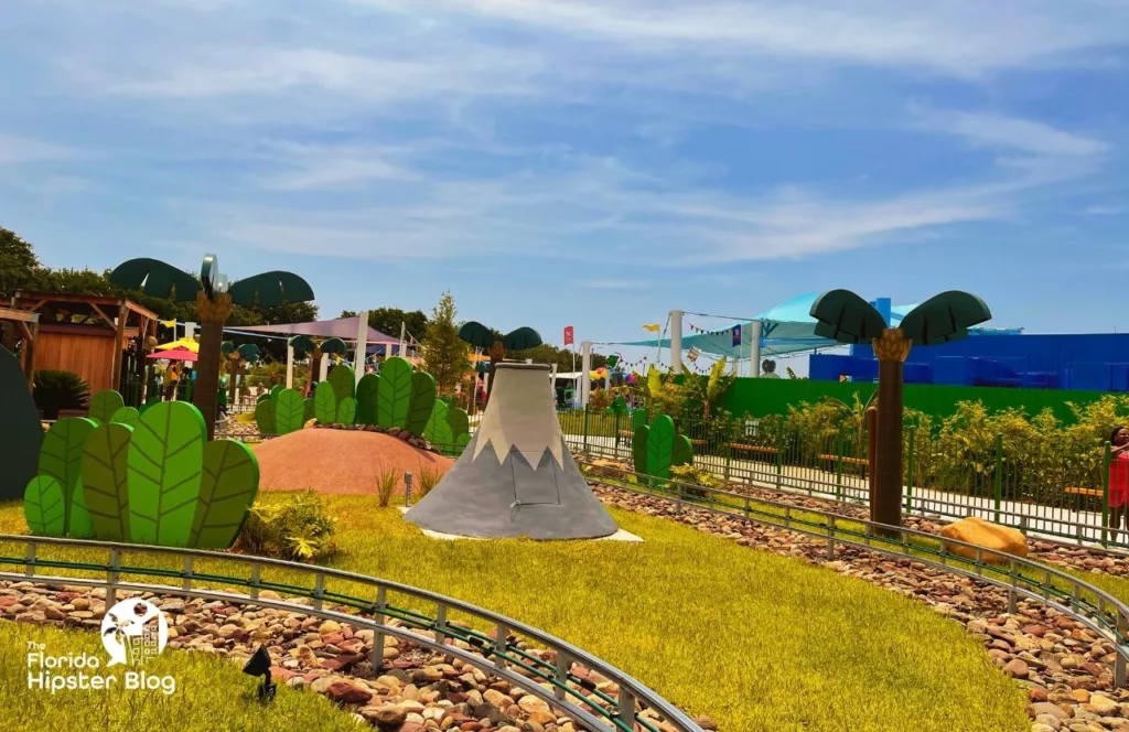 Peppa Pig Theme Park Florida Grampy Rabbit's Dinosaur Adventure with Gray Volcano. Keep reading to find out all the things to do at Peppa Pigs Theme Park.  