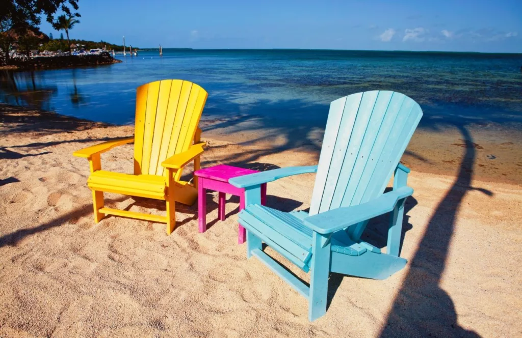 Florida Keys lounge chairs on sandy beach. Keep reading to learn about the best Florida beaches for a girl's trip!