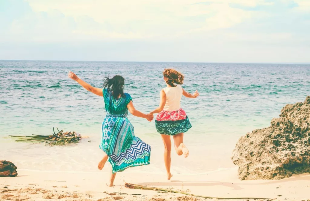 Girls Weekend on a Florida Beach with women running on the beach. Keep reading to learn where to go for a girl´s trip in Florida. 