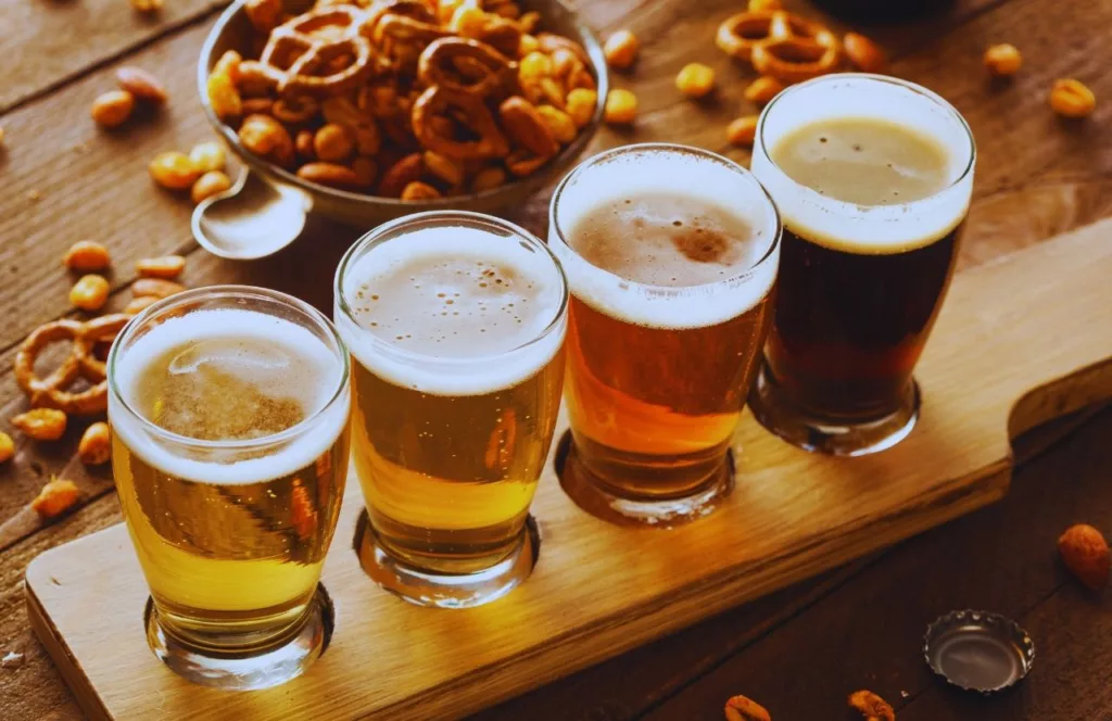 Flight of beer and snacks on the table. Keep reading to find out all you need to know about Gainesville bars.