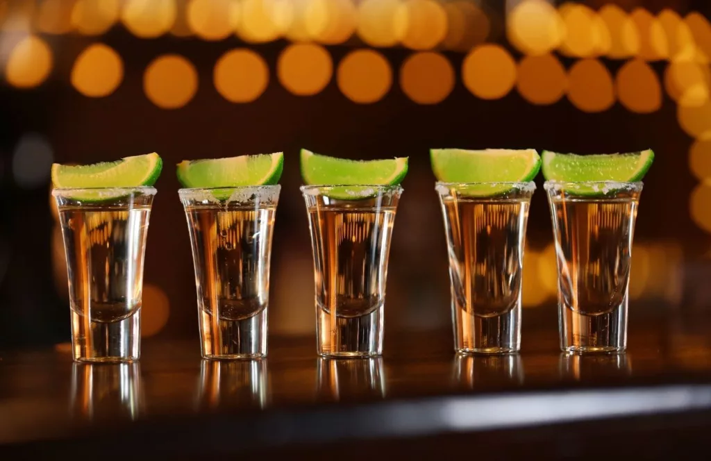 Tequila shots lined up on the bar. Keep reading to discover the best things to do in Gainesville at night.