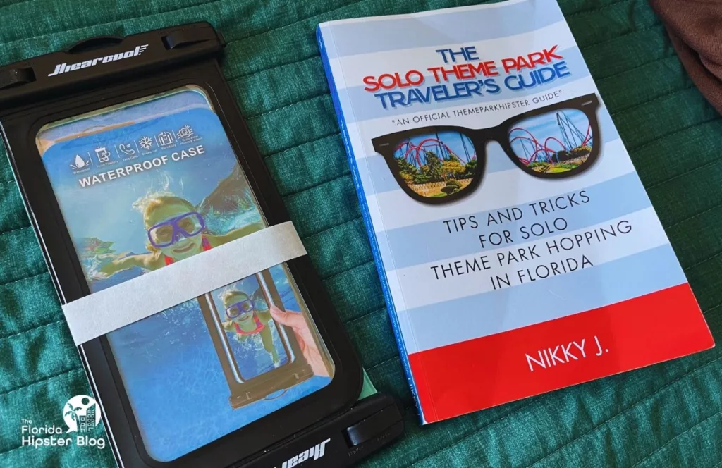 Keep reading learn about what to pack for Florida and how to create the best Florida Packing List Waterproof Phone Case next to The Solo Theme Park Traveler's Guide by NikkyJ