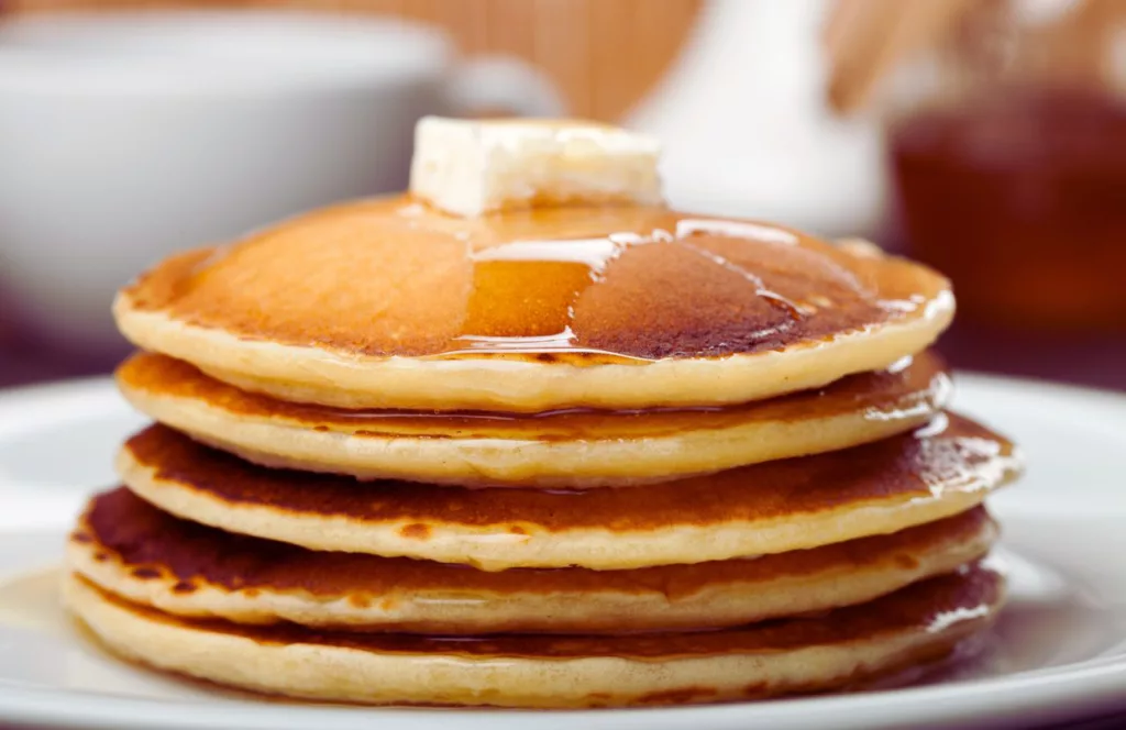 Keep reading to get the best breakfast in Tampa. Shelley's Cafe Pancakes with butter on top