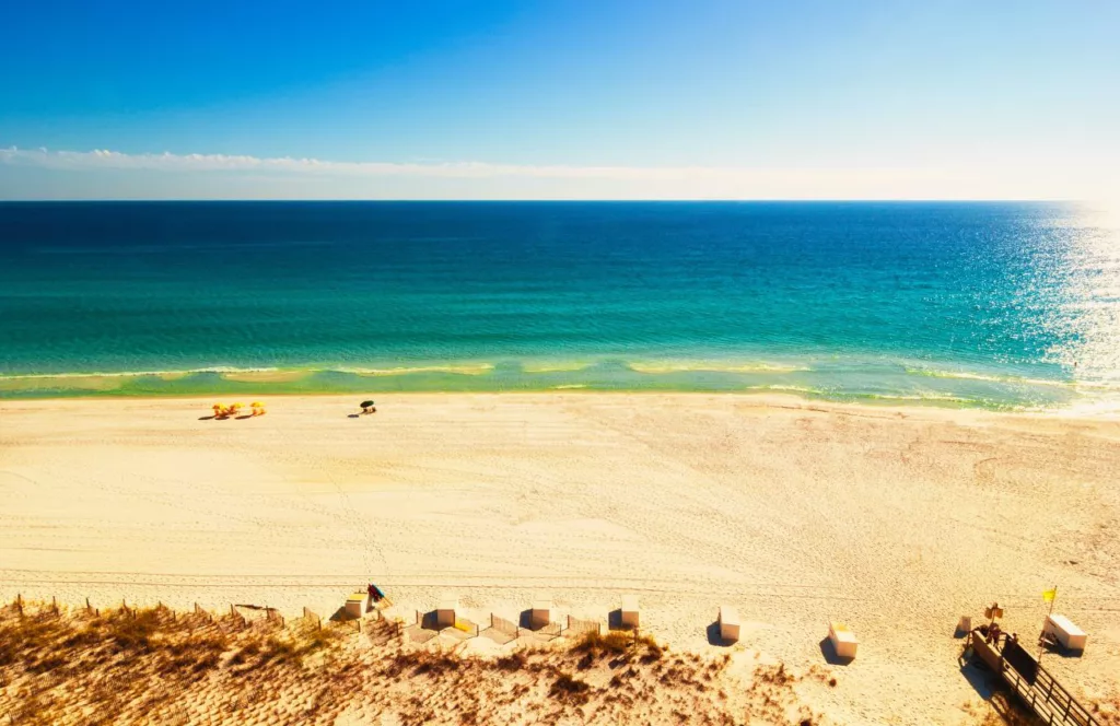 Emerald water of Miramar Beach in Destin Florida with wide open sandy space. Keep reading to find out more about the free beaches in Destin Florida.