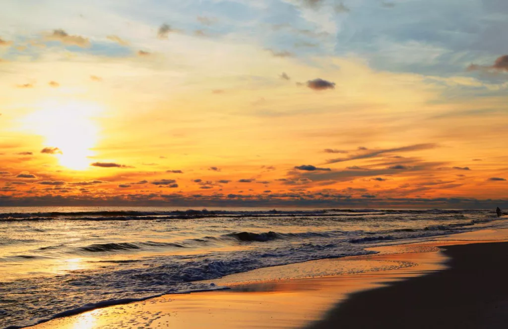 Beach sunset with a sky full of oranges and blue. Keep reading to discover all there is to know about Margaritaville Beach Hotel Jacksonville.