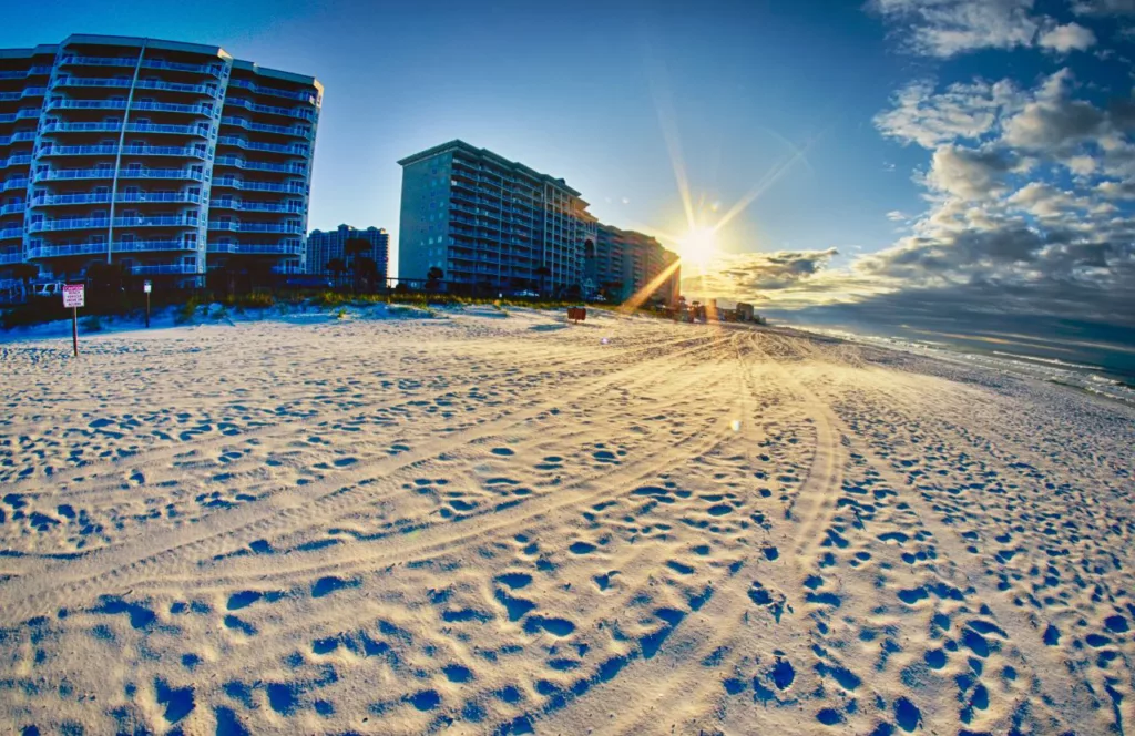 Destin, Florida with white sands and hotels at sunrise. Keep reading to learn about the best Florida beaches for a girl's trip!