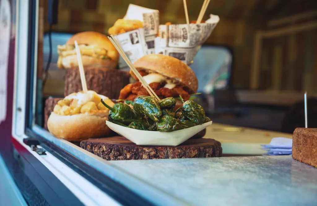 Various sandwiches next to roasted jalapeño peppers at the Food Truck window. Keep reading to find out all you need to know about the best things to do for Independence Day in Florida.    