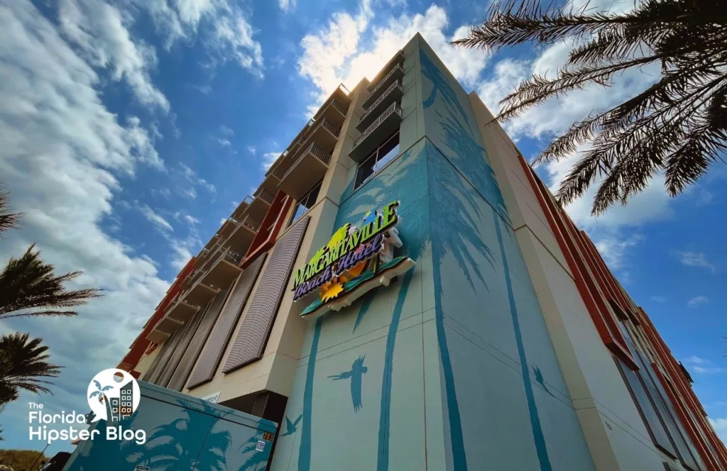 Outside view looking up of Margaritaville Resort Jacksonville Hotel with its colorful sign. Keep reading to find out more about Margaritaville Beach Hotel Jacksonville.